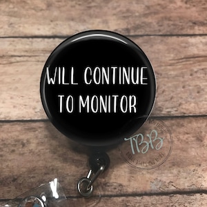 May include: Black retractable badge reel with a white circle that says "WILL CONTINUE TO MONITOR".