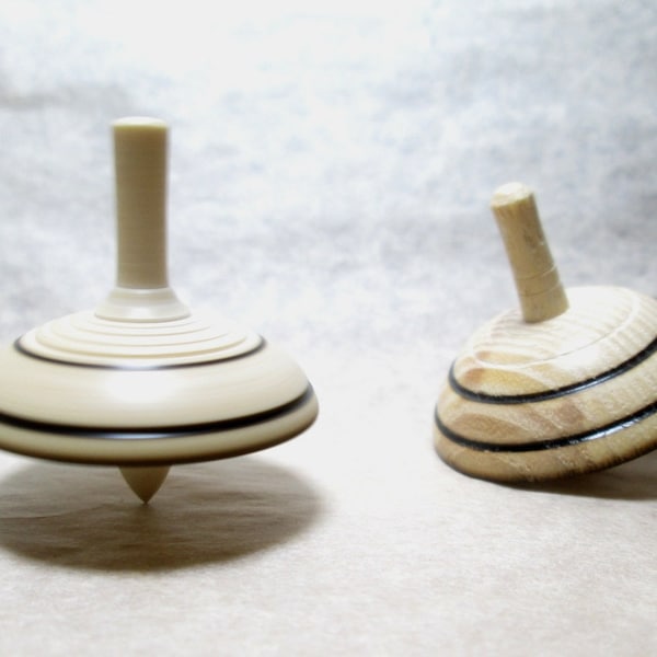 Set of two spinning tops, white and black, ashwood, manual woodturning