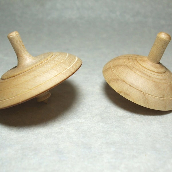 Set of two pretty tops in beech and maple wood made with a manual lathe, manual woodturning