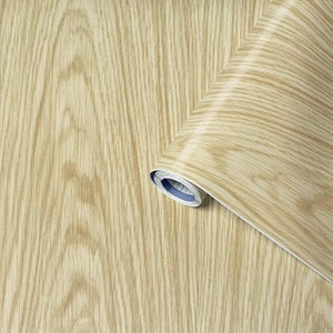 May include: A roll of wood-grain contact paper. The paper is light brown with a wood grain pattern. The roll is partially unrolled, showing the paper's texture.