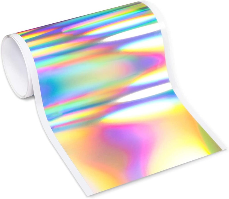 May include: A roll of iridescent holographic vinyl with a rainbow color pattern. The vinyl is rolled up and the end is unfurled, showing the iridescent colors.
