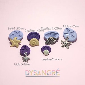 May include: Purple silicone moulds for making resin jewellery. The moulds are shaped like seashells and starfish. The moulds are labelled with the size of the finished piece in millimetres. The text "Étoile 1 - 20mm", "Coquillage 1 - 15mm", "Coquillage 2 - 23mm", "Étoile 2 - 21mm", "Coquillage 3 - 10mm", "Étoile 3 - 17mm", and "DYSANGRÉ" is visible in the image.