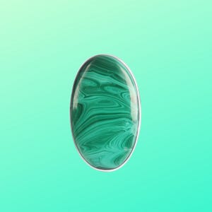 May include: A green malachite gemstone ring with a silver setting. The stone has a swirling pattern of green and black.