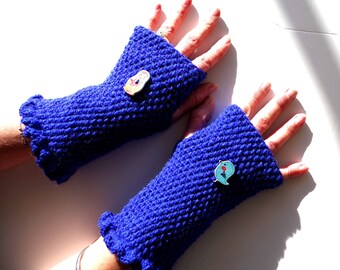 Crocheted mittens in king blue penguin wool they are adorned with two painted wooden buttons representing a