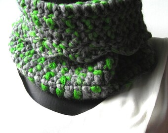 Snood crocheted in large green and grey Katia Punto wool and is 17 cm long and 34 cm wide at the base.