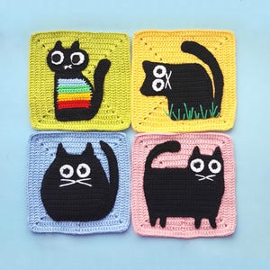 May include: Four crocheted squares featuring black cats with different expressions. The squares are in yellow, blue, pink, and green.