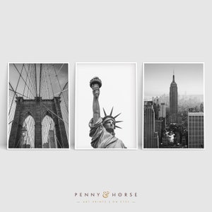 May include: A set of three black and white photographs featuring iconic New York City landmarks: the Brooklyn Bridge, the Statue of Liberty, and the Empire State Building.