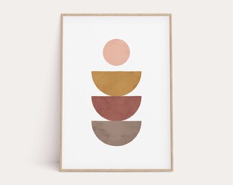May include: Abstract art print with a stack of five semi-circles in shades of pink, brown, and gold. The print is framed in a light wood frame.