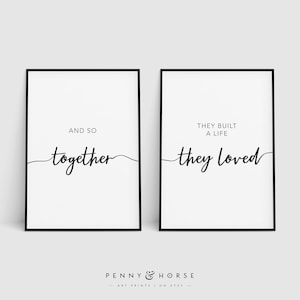 May include: Two black framed prints with white backgrounds and black text. The left print says "And so together" with a cursive line. The right print says "They built a life they loved" with a cursive line.