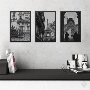 May include: Three black framed photographs of Paris, France. The left photo shows a bicycle parked on a cobblestone street. The middle photo shows the Eiffel Tower from a street level perspective. The right photo shows a silhouette of two people walking in front of a building.