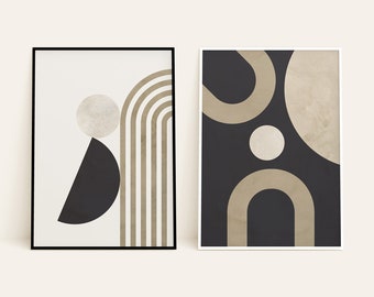 May include: Two framed abstract art prints. The left print has a black frame and features a black semi-circle, a beige circle, and beige arches on a cream background. The right print has a white frame and features beige shapes on a dark background.