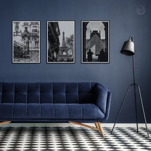 May include: Three black and white framed photographs of Paris, France. The photos show a street scene with a bicycle, the Eiffel Tower, and a view of the Louvre Museum.