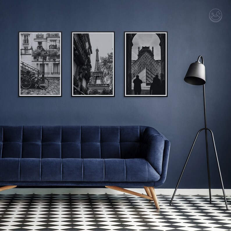 May include: Three black and white framed photographs of Paris, France. The photos show a street scene with a bicycle, the Eiffel Tower, and a view of the Louvre Museum.