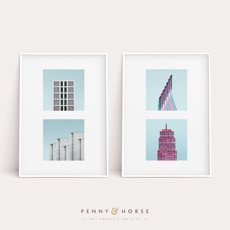 May include: Two framed prints of minimalist architectural photography. The left print features a light blue background with two images of a building with a geometric design. The right print features a light blue background with two images of a tall, red building.
