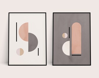 May include: Two abstract geometric prints with a minimalist design. The prints feature a combination of circles, semi-circles, and rectangles in shades of pink, gray, and white. The prints are framed in black.