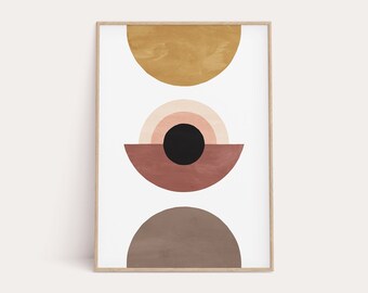 May include: Abstract geometric art print with three semi-circles in shades of brown, pink, and yellow. The print features a black circle in the center of the pink semi-circle.