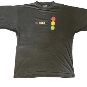 May include: Black t-shirt with a graphic of a traffic light and the text "blink-182" printed on the front.
