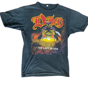 May include: Black t-shirt with a red and yellow graphic of a band called "DIO" and the words "The Last in Line".