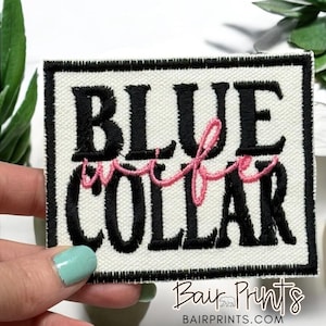 May include: White embroidered patch with black text that reads "BLUE collar" with the word "collar" in pink.