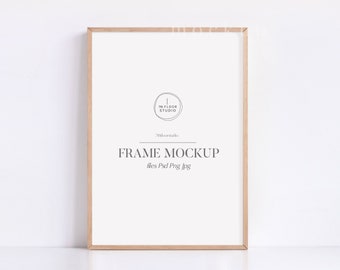 May include: A light brown wood frame mockup with the text "FRAME MOCKUP" and "files: Psd Png Jpg" printed on the white background. The text "The Floor Studio" is printed in a circle in the upper left corner of the frame.