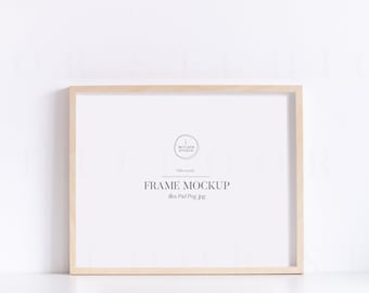 May include: A light wood frame mockup with a white background. The frame is on a white surface. The text "FRAME MOCKUP" is in the centre of the frame. The text "files: Psd Png Jpg" is below the text "FRAME MOCKUP".
