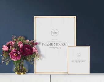 May include: Two gold picture frames with white mats and the text "FRAME MOCKUP" on a white surface. The larger frame is on the left and the smaller frame is on the right. A vase with pink and burgundy flowers is in front of the frames.