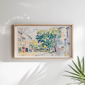 May include: A framed watercolor painting depicting a street scene with buildings and a large tree in the center. The painting is done in a variety of colors, including blue, green, yellow, and white.