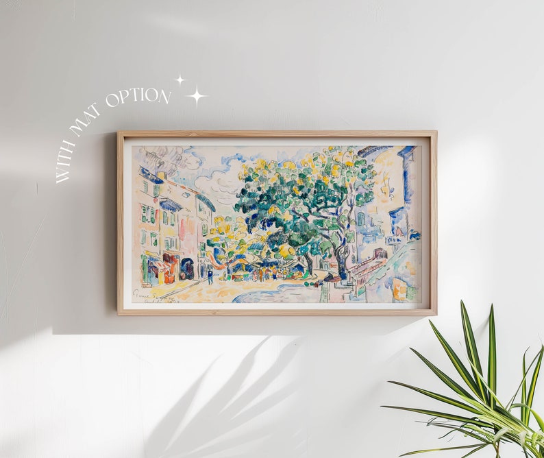 May include: A framed watercolor painting depicting a street scene with buildings and a large tree in the center. The painting is done in a variety of colors, including blue, green, yellow, and white.
