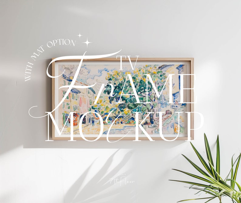 May include: A framed watercolor painting of a street scene with buildings and trees. The frame is light wood with a white mat. The text "TV FRAME MOCKUP" is written in white cursive letters over the image.