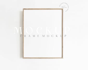 May include: A light wood frame mockup with a white background. The frame is hanging on a white wall. The text "MOCKUP FRAME MOCKUP" is written below the frame.