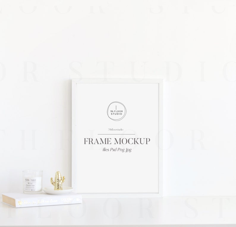 May include: White frame mockup with the text "FRAME MOCKUP" and "files Psd Png Jpg" on a white surface with a small cactus and candle.