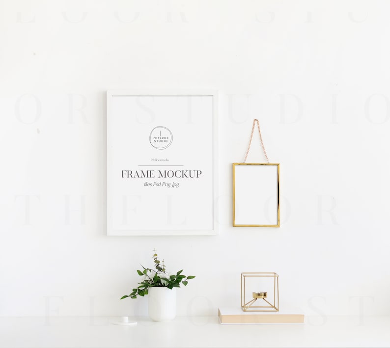 May include: White frame mockup with a gold frame hanging above a white table with a small potted plant and a gold candle holder. The text on the white frame reads "FRAME MOCKUP 11x14 inches".