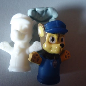 May include: Three finger puppets, one is white, one is blue and one is brown with a yellow face and blue hat. The blue puppet has a badge on its chest.