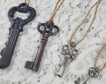 Vintage Skeleton keys set of 4 with jute tie mini metal pendants silver and brown bronze colors various sizes