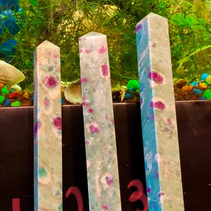 May include: Three polished gemstone towers in green, blue, and white with pink and purple flecks. The towers are labelled 1, 2, and 3.