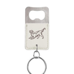 May include: White leather bottle opener keychain with a brown outline of a dog. The keychain has a silver bottle opener and a silver key ring.
