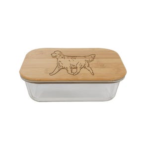 May include: A glass container with a bamboo lid featuring a laser-engraved image of a golden retriever. The container is perfect for storing food or other items.