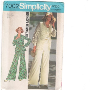 May include: Simplicity sewing pattern featuring a woman in a white pantsuit and a woman in a green floral pantsuit. The pattern is labeled "Designer Fashion" and includes size 12 and bust 34 inches.
