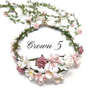 May include: A floral crown with pink and white flowers and green leaves. The crown is labeled "Crown 5".