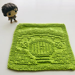 May include: A green knitted dishcloth with a textured design.