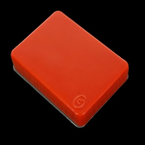 May include: A bright red rectangular hard drive with a small, raised, circular logo in the center.