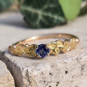 18K red gold wedding ring and a tanzanite.