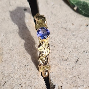 18K red gold wedding band and a tanzanite.