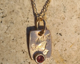 Pendentif or jaune 18 K et un saphir orange.