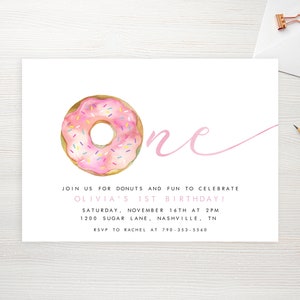 May include: Pink and white donut with sprinkles, a pink cursive "one" and text that reads "Join us for donuts and fun to celebrate Olivia's 1st birthday! Saturday, November 16th at 2pm 1200 Sugar Lane, Nashville, TN RSVP to Rachel at 790-353-5560"