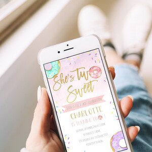 May include: A pink and white digital invitation with a gold glitter font that says "She's Two Sweet". The invitation features a donut with pink frosting and sprinkles and a donut with green frosting and sprinkles. The invitation also includes the text "Join us for a sweet celebration" and "Charlotte is turning two!"