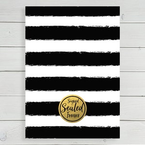 May include: Black and white striped background with a gold circle that says "Signed Sealed Forever".