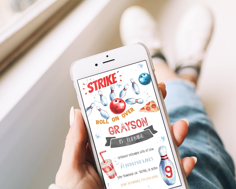 May include: A smartphone displays a bowling-themed birthday invitation. The design features a red bowling ball, blue pins, and the text "STRIKE" and "ROLL ON OVER GRAYSON IS TURNING". Additional elements include a pizza slice and a soda cup.