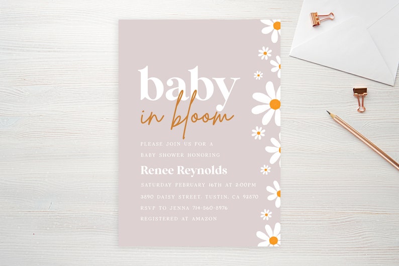 May include: A light purple baby shower invitation with white daisies with yellow centers along the right side. The text reads "baby in bloom" in white and orange lettering. The invitation includes the date, time, location, RSVP information, and registry information.