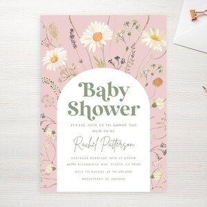 May include: A pink baby shower invitation with a white arch and green text that reads "Baby Shower". The invitation is decorated with white daisies and other floral elements.